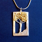Pendant: silver rectangle framing silhouette of tree with gold branches
