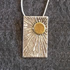 Rectangular (portrait) pendant, gold sun in top right corner with radiating beams
