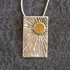 Rectangular (portrait) pendant, gold sun in top right corner with radiating beams
