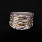 Wide ring with interleaving waves of gold and silver