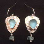 Beaten silver earrings with pale glass centres and tiny pendant fragments