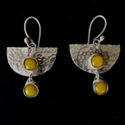 Earrings: inverted stippled silver semicircles with two tiny dangling amber orbs
