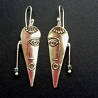 Earrings: primitive face design