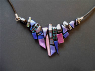 Dichroic glass necklace adornment: a mosaic of tiny pieces of different patterns and shades of mauve