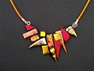 Dichroic glass necklace adornment: a mosaic of tiny pieces of different patterns and shades of red and gold