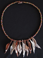 Necklace: brown beads with curling leaves