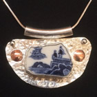 Pendant: beaten silver base with gold and silver studs; inset fragment of willow pattern china