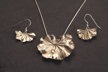 Pendant: alchemilla leaf with single droplet; matching earrings