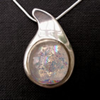 Teardrop silver pendant with clear circular dichroic glass inset