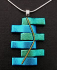 Pendant: offset interleaved bricks of dichroic glass in shades of turquoise