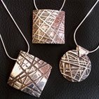 Three pendants with criss-cross markings