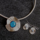 Silver flower pendant with turquoise dichroic glass centre; matching earrings