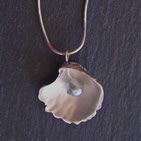 Pendant: silver scallop shell with glass bead