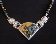 Bead necklace with pendant: two scarab beetles holding colourful china fragment in silver setting