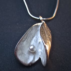 Oyster shell pendant revealing pearl