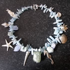 Pebble-bead bracelet with silver sea-theme charms: shells, seahorse, starfish