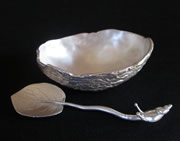 Silver acorn-design bowl; small silver spoon with leaf scoop and snail grip handle